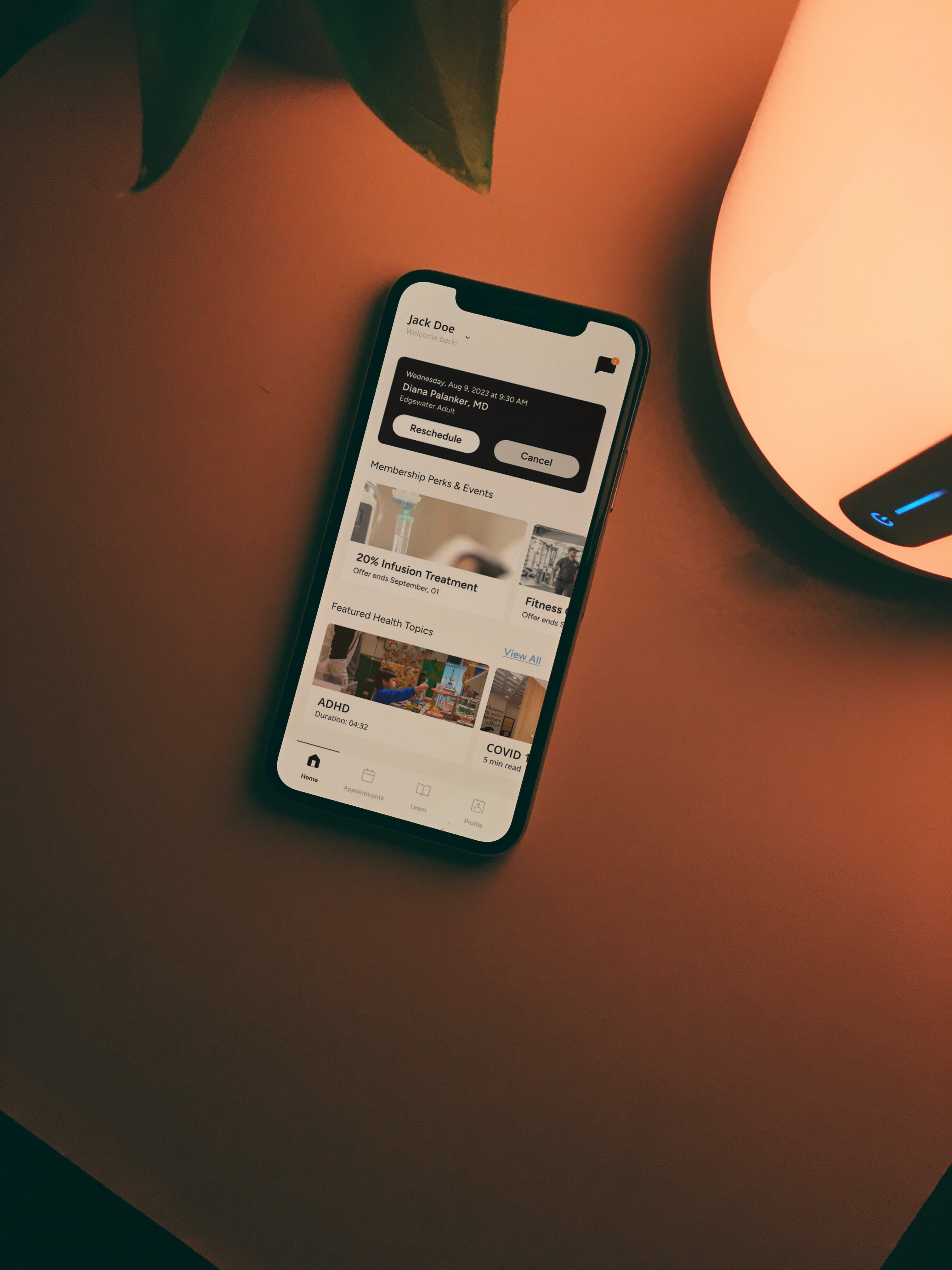 mobile phone in warm tone scene, with baker health app visible on screen